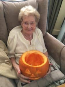 lady resident with pumpkin