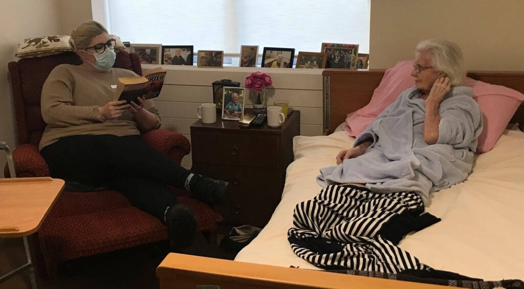 Caroline and resident reading together