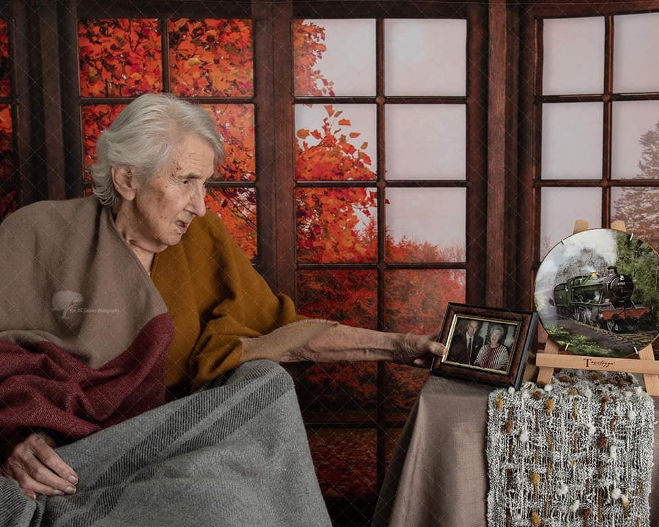 lady resident with framed photo with husband - Autumn photo shoot
