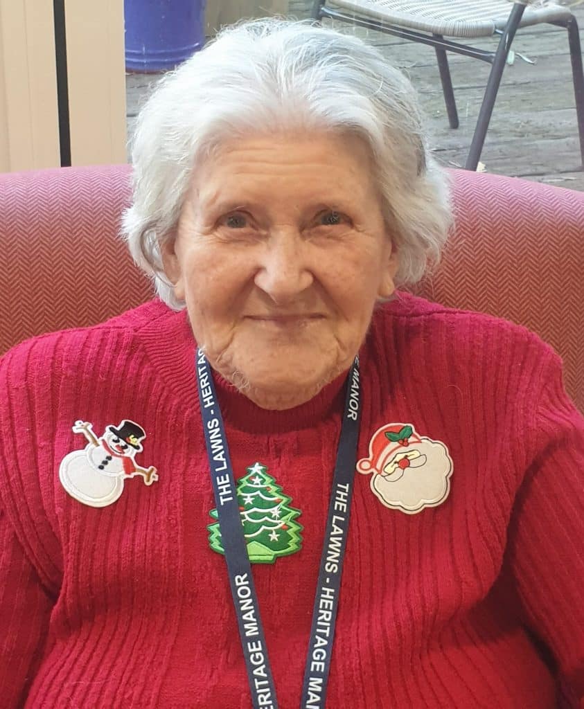 Christmas Jumper day - lady resident in red jumper with lanyard