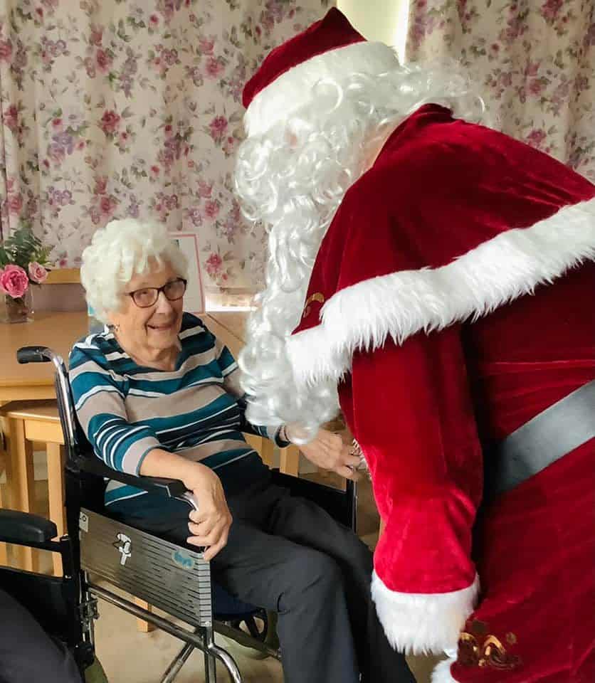 Resident is striped top delighted to see Santa