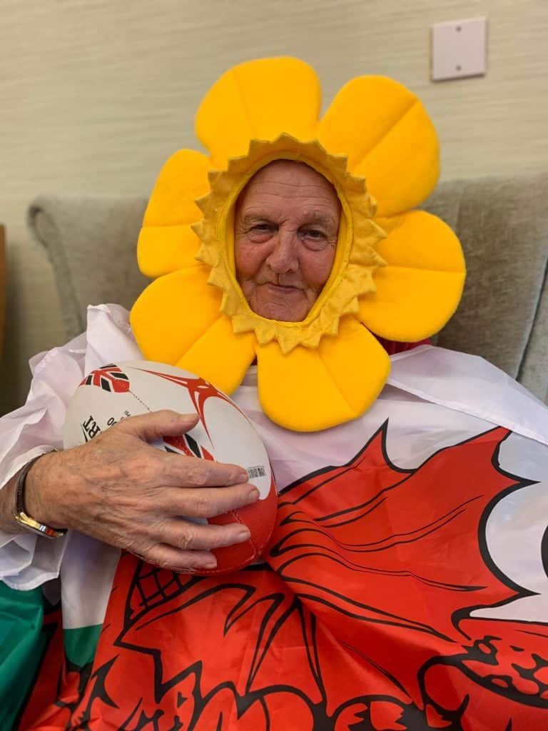 St Davids Day gentleman resident with daffodil hat and rugby ball