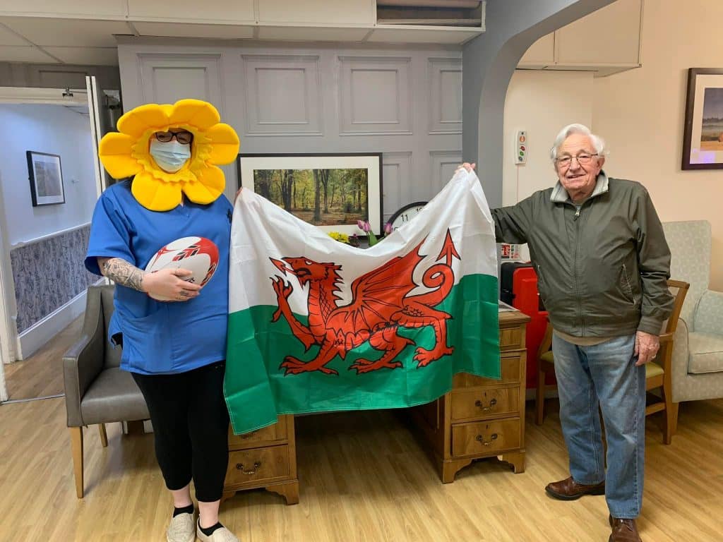 Resident and team with Welsh flag