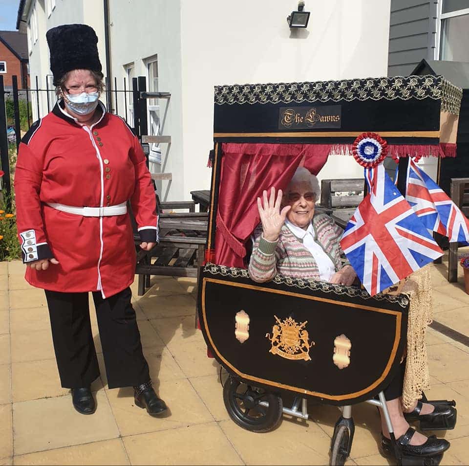 Joy as a beefeater with resident in the royal carriage