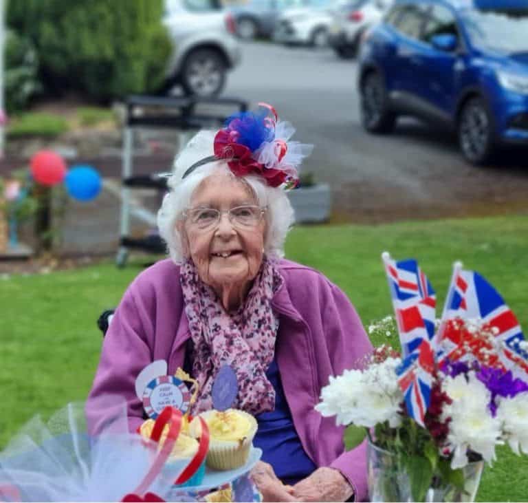 Jubilee party lady with fascinator in garden