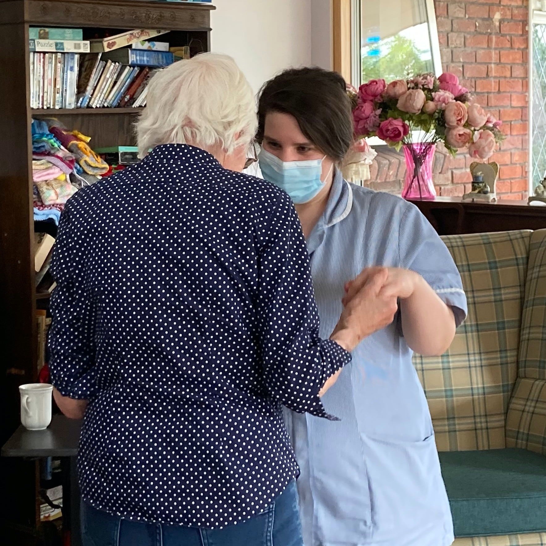 resident and carer dancing together at West Eaton