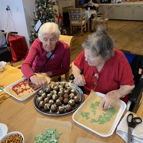 two lady residents and xmas baking - feeling proud