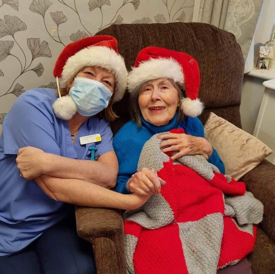 resident and nurse in santa hats