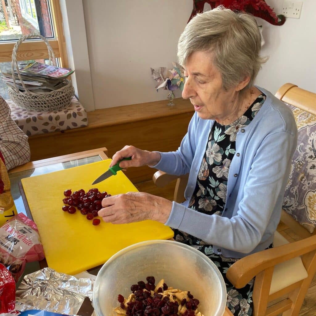 Catering team - lady resident chopping cherries