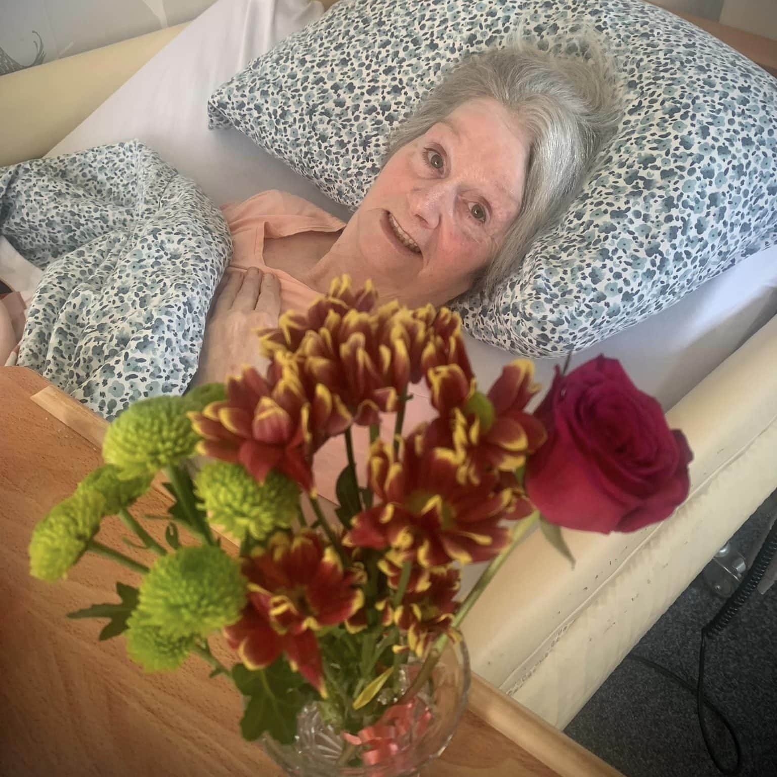 lady resident in bed with flowers