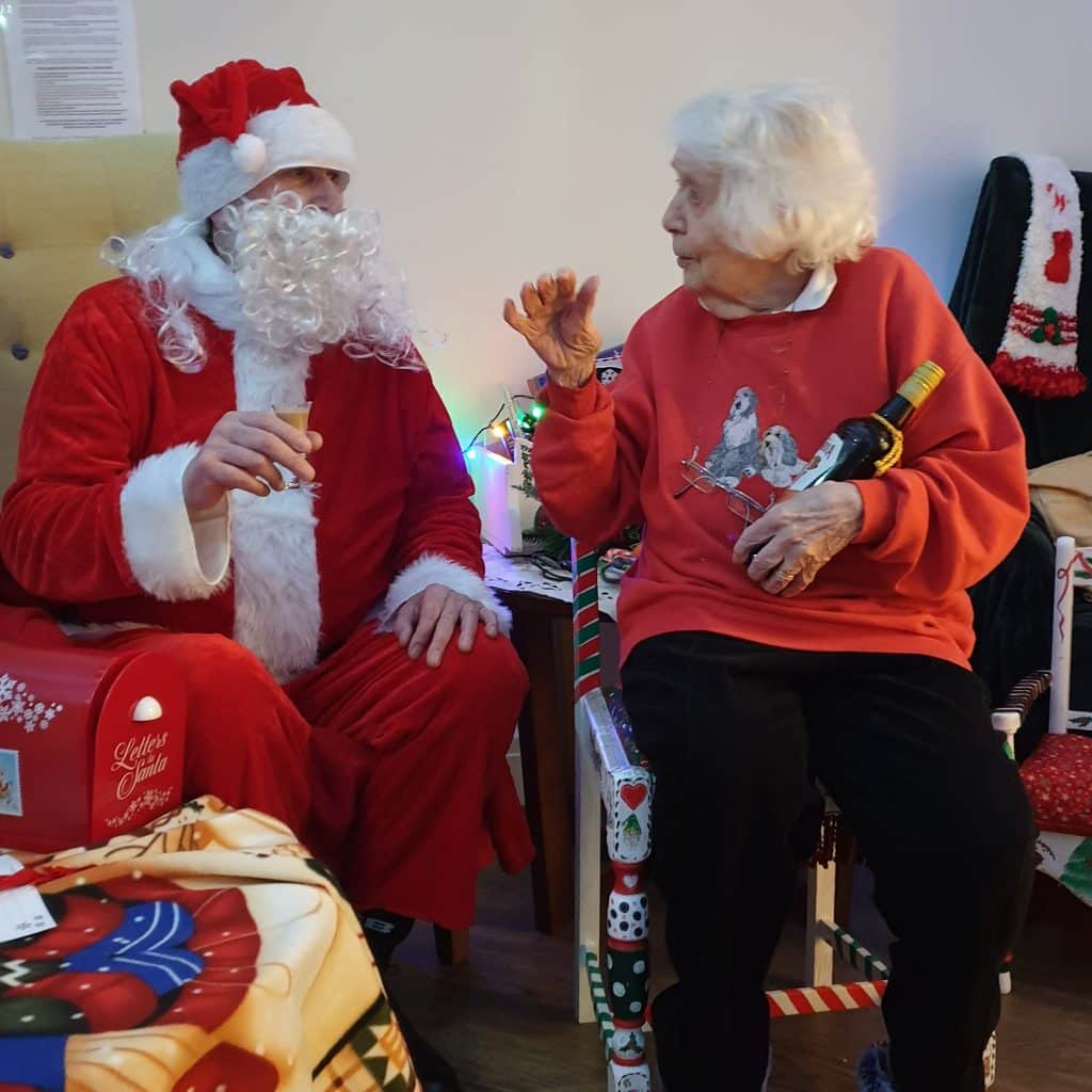 resident in red jumper with Santa
